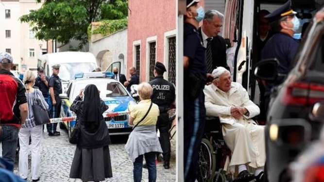 Benedicto escoltado por la policía alemana mientras los fieles hacen fotos