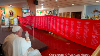 El Papa besa la inmensa lona con los nombres de las víctimas