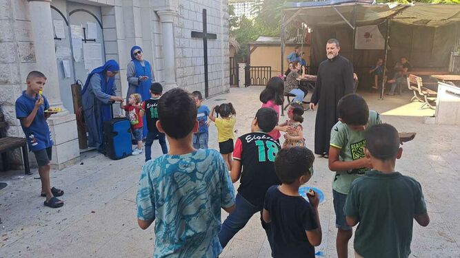 Hora del almuerzo para unos niños en el patio de la parroquia en Gaza