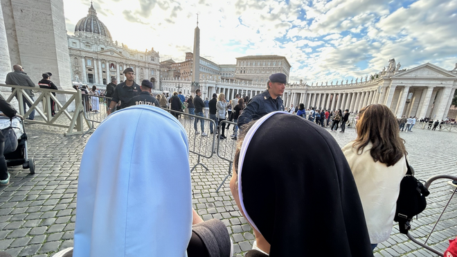 Dos religiosas miran hacia la chimenea sobre la Sixtina